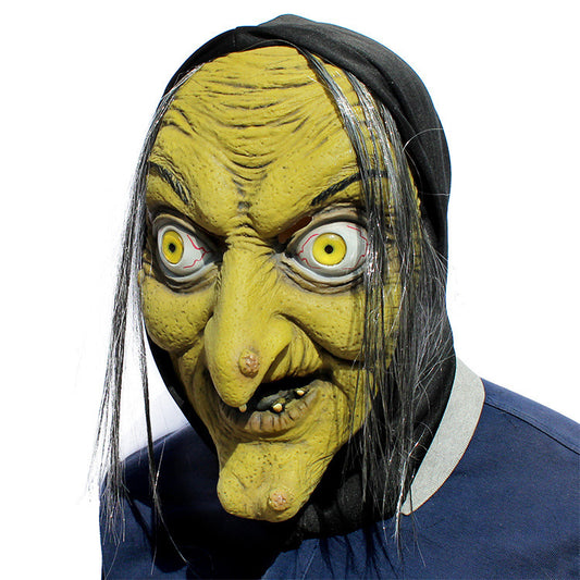Latex witch mask front view — yellow-green aged skin with wild yellow eyes and silver-streaked hair