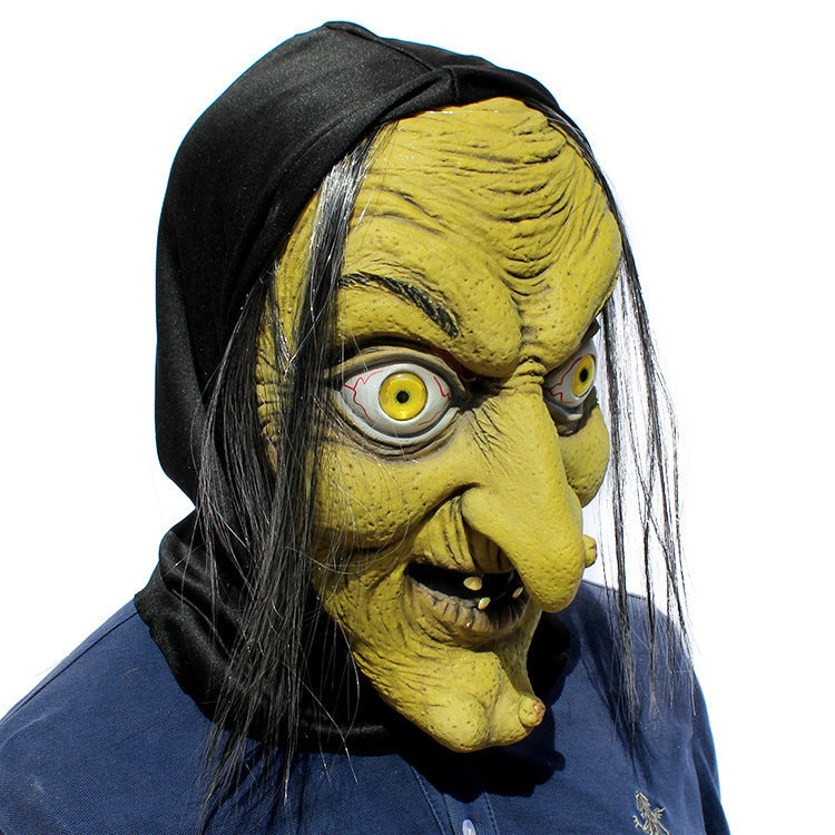 Latex witch mask three-quarter angle — deeply textured wrinkles and hooked nose catching natural light